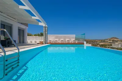 a swimming pool with a view of a building at Villa Hermes with pool & jacuzzi in Lindos in Líndos