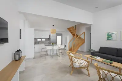 a living room with a couch and a table at Villa Hermes with pool & jacuzzi in Lindos in Líndos