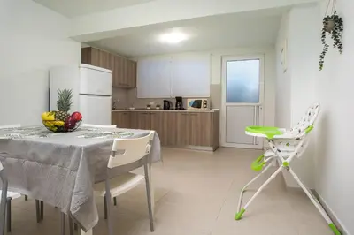 a kitchen and dining room with a table and chairs at Stegna Paradise View in Archangelos