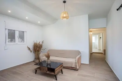 a living room with a bed and a table at Stegna Paradise View in Archangelos