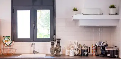 a kitchen counter with a sink and a window at Papenas Cozy Home in Faliraki