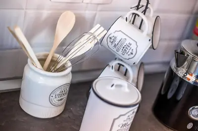 a kitchen counter with a cup and utensils at Papenas Cozy Home in Faliraki