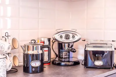 a kitchen counter with a blender and a toaster at Papenas Cozy Home in Faliraki