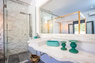 a bathroom with a sink and a mirror at Papenas Cozy Home in Faliraki