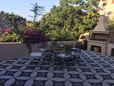 a patio with a table and chairs on a tile floor at Tafros Villa in Rhodes Town