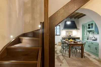 a kitchen with stairs leading to a dining room with a table at Tafros Villa in Rhodes Town