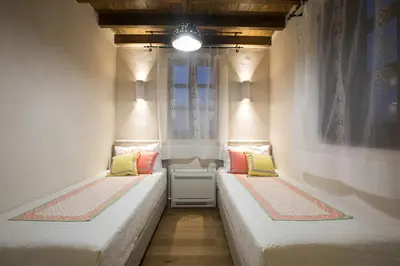 two beds sitting in a room with a window at Tafros Villa in Rhodes Town
