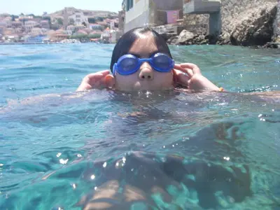 a young child wearing goggles in the water at Villa Amalia in Halki