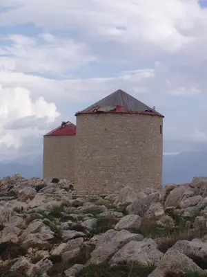 a building on top of a pile of rocks at Villa Amalia in Halki