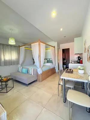 a living room with a bed and a table at M&N Apartments in Archangelos