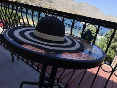 a hat sitting on a table on a bench at Korali in Symi