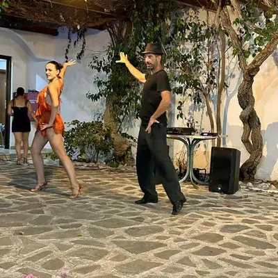 a man and a woman dancing on a patio at BELVITA Hotel in Kolimbia