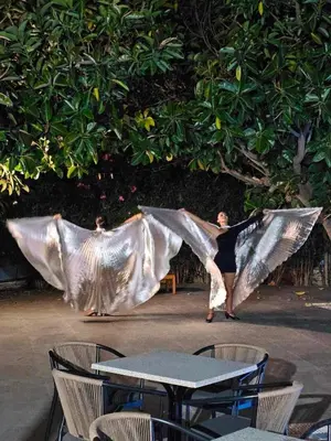 a woman is dancing in front of a tree at BELVITA Hotel in Kolimbia