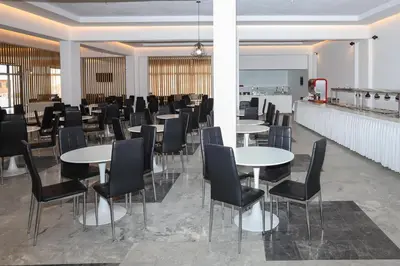 a row of tables and chairs in a restaurant at BELVITA Hotel in Kolimbia
