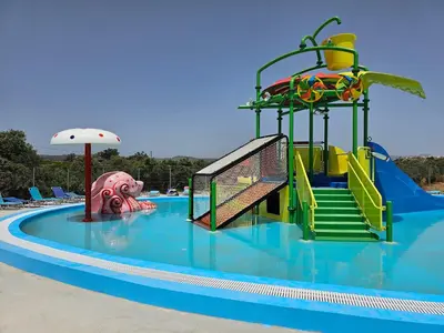 a water slide in a swimming pool at BELVITA Hotel in Kolimbia