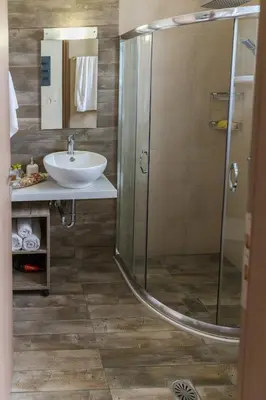 a bathroom with a sink and a shower at Haraki Blue Pearl in Haraki