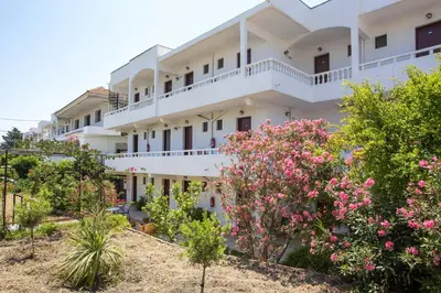 a building with flowers in front of it at Marieta-Giannis in Faliraki