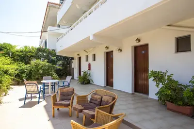 a patio of a house with chairs and a table at Marieta-Giannis in Faliraki