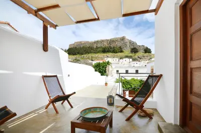 a view from the balcony of a house with two chairs at Casa Lindos in Líndos