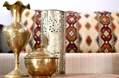 a group of vases sitting on top of a table at Casa Lindos in Líndos