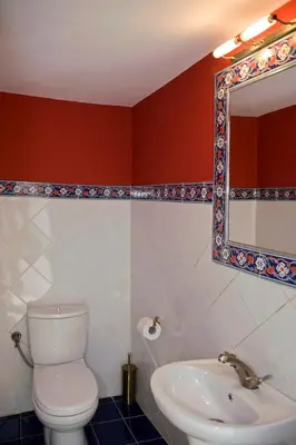 a bathroom with a toilet and a sink and a mirror at Casa Lindos in Líndos