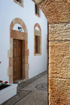 a hallway with a wooden door in a building at Casa Lindos in Líndos