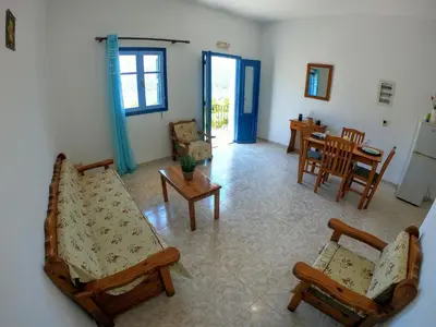 a living room with a couch and chairs and a table at Irene Double Apartment Katoi in Symi