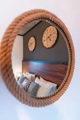 a mirror with two clocks on top of a bed at amara luxury villas in Lachania