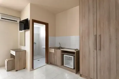 a small bathroom with a sink and a toilet at Rose Hotel Faliraki in Faliraki