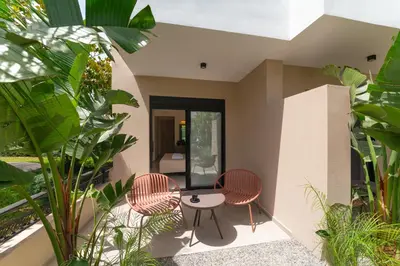 a room with two chairs and a table and some plants at Hippocampus Boutique Hotel in Ixia