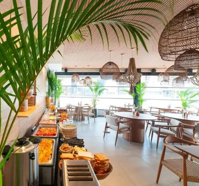 a restaurant with tables and chairs and food on display at Hippocampus Boutique Hotel in Ixia
