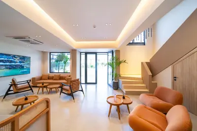 an office lobby with orange chairs and tables at Hippocampus Boutique Hotel in Ixia