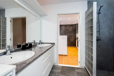 a bathroom with two sinks and a shower at Southern Dreams Apartments in Gennadi