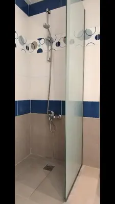 a shower with a glass door in a bathroom at Christiana Hotel Apartments in Gennadi