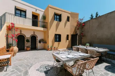 a patio with tables and chairs in front of a building at Zacosta Villa - a Heritage Hotel in Rhodes Town