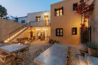 a patio with tables and chairs in front of a building at Zacosta Villa - a Heritage Hotel in Rhodes Town