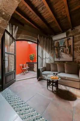 a living room with a couch and a table at Zacosta Villa - a Heritage Hotel in Rhodes Town