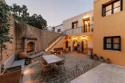 an outdoor patio with a table and chairs at Zacosta Villa - a Heritage Hotel in Rhodes Town