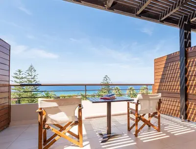 a balcony with a table and two chairs at D'Andrea Mare Hotel in Ialyssos