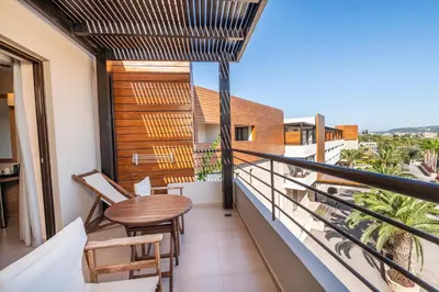a balcony with a table and chairs and a view at D'Andrea Mare Hotel in Ialyssos