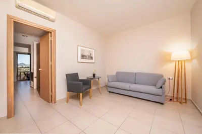 a living room with a couch and a table at D'Andrea Mare Hotel in Ialyssos