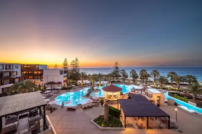 an aerial view of a resort with a pool and the ocean at D'Andrea Mare Hotel in Ialyssos