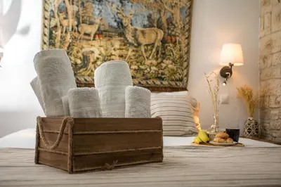 a wooden box filled with rolls of toilet paper on a bed at Anna's House Traditional in Halki