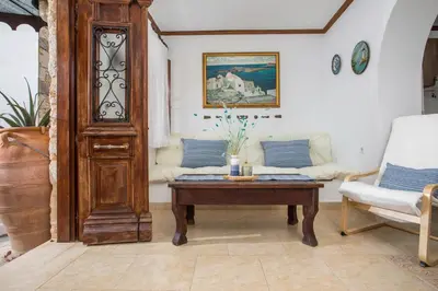 a living room with a table and a couch at Anna's House Traditional in Halki