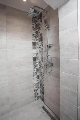 a bathroom with a shower with a glass door at Anna's House Traditional in Halki