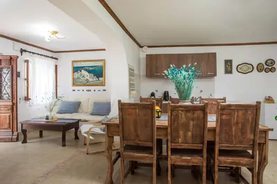 a living room with a table and chairs and a couch at Anna's House Traditional in Halki