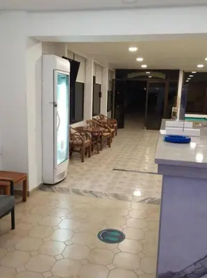 an empty room with chairs and a refrigerator at Butterfly Studios, Faliraki in Faliraki