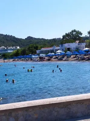 a group of people in the water at a beach at Butterfly Studios, Faliraki in Faliraki