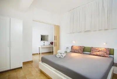 a bedroom with a large bed in a room at Sabrina Studios in Faliraki