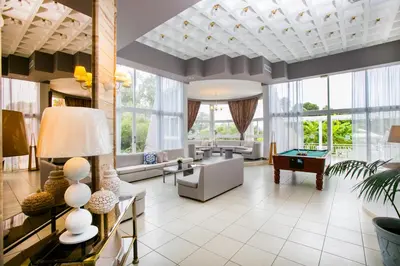 a living room with a lot of windows at Happy Days Hotel, Adults Only in Theologos